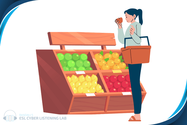 Person holding an apple in front of a produce display.